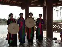 A Quan họ ensemble holding quai thao hats duiring a performance at Đô temple, 2014