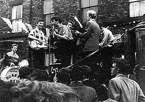 The Quarrymen performing in Rosebery Street, Liverpool, on 22 June 1957 (Left to right: Hanton, Griffiths, Lennon, Garry, Shotton and Davis)