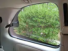 Interior view of a venting quarter glass in the rear of an American minivan between the C-pillars and the D-pillars