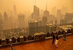 A view of nearby buildings from Top of the Rock; there is orange haze in the background due to the 2023 United States East Coast wildfire smoke