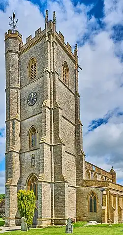 Stone building with square tower.