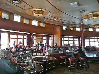 Observation Bar lounge. The windows were once part of the enclosed Promenade Deck turnaround; the lounge was extended forward after 1967.