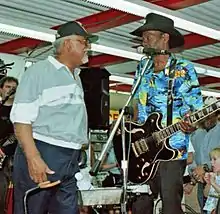 Quezergue (left) greeting Clarence "Gatemouth" Brown, New Orleans, 1997