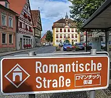 Romantic Road sign in southern Germany (note the Alps in the background)