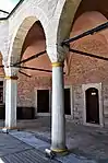 A round column (mid) and a polygonal column (left) of the courtyard's colonnad