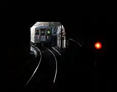 An R68 G train having just left the station