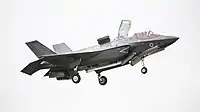 F-35B showing weapon's bay inboard doors open to capture rising fountain flow