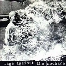 A black-and-white image of a bald man being burned alive. The album/band name is shown in the bottom in lowercase letters with a black background.