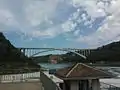 The bridge as viewed from the Canadian side, with collapsed Schoellkopf Power Station visible distant cliff face