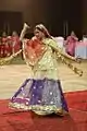 Woman with a ghoonghat performing a Ghumar dance.