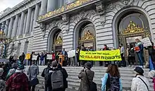 Rally on the steps of San Francisco City Hall, protesting against a vote to authorize police use of deadly force robots.