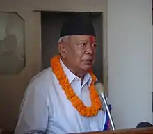 Ramsharan Darnal standing in front of a podium