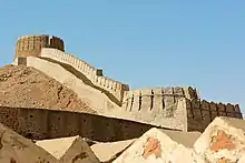 A stone wall and a bastion on the top of a hil