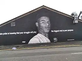 Black-and-white portrait painting on wall of footballer and social campaigner Marcus Rashford