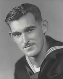 A black-and-white photograph of Evans, showing his head and shoulders, wearing the dress blues of a Coast Guard enlisted man