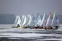 International DN class iceboats at the start of a race in Znin, Poland