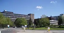 A roundabout with a number of 1970s office blocks and green landscaping