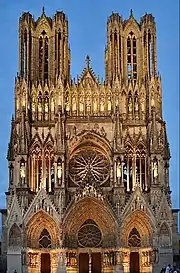 Notre-Dame de Reims façade, gothic stone cathedral against blue sky