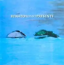 Blue square with two egg-shaped unidentified objects drawn in the middle and 'Renato Russo Presente' written on center-top.