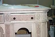 a closeup view of an ornately carved drawer front