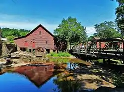 The NRHP listed Rex Mill, as seen from the side of Mill Walk west of the one-lane bridge.