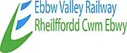 Logo has a stylised capital 'E' to the left; spine of the 'E' is boomerang shaped in green also forming the lower stroke; upper two strokes are blue. The name 'Ebbw Valley Railway' (written in the same colour blue as the logo) is above the name 'Rheilfford Cwm Ebwy' (written in the same colour green as the logo)