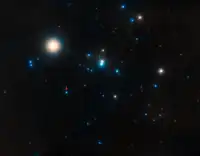 Hyades, with ρ Tau appearing blue, left of center, marked with a red arrow