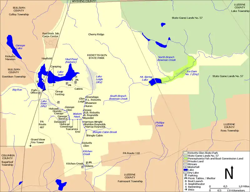 A map showing Kitchen Creek flowing southeast from Ganoga Lake, through Lake Jean, and then through the dry bed of Lake Rose into Ganoga Glen with ten waterfalls. A second branch of the creek flows south through the dry bed of Lake Leigh, then through Glen Leigh and its eight waterfalls. These branches meet at Waters Meet and the creek flows south through Ricketts Glen and its six waterfalls. The South Branch Bowman Creek is east of Lake Leigh and Big Run is west of Lake Rose. Pennsylvania Route 487 runs north-south at left, and Pennsylvania Route 118 runs east-west at the bottom of the map. County borders are also shown.