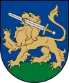 A coat of arms depicting a golden lion holding a silver-bladed sword in its mouth with a golden hilt and standing on green turf all on a blue background
