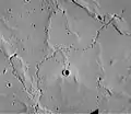 Most of the Rimae Herigonius and Herigonius K crater (below center). The rimae (rilles) extend to the south out of the picture.