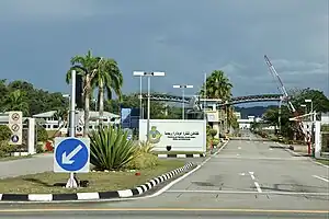 Photograph showing the main entrance to the Royal Brunei Air Force Base, Rimba, with the barrier gates in a raised position.