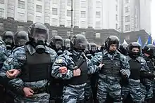 Defensive line of "Berkut" unitmen in riot gear by the Cabinet of Ministers building in Kyiv during 2013 Euromaidan protests.