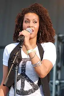 Rissi Palmer singing in a live concert in the year 2008.
