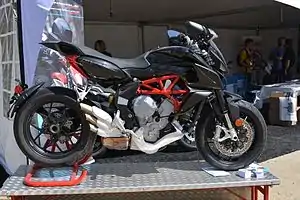 Black motorcycle with red frame and white exhaust