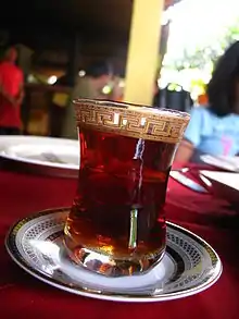 A glass of red-colored tea