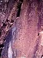 Paleolithic rock engravings breaking the natural rock formation