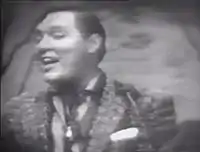 Bill Haley of Bill Haley & His Comets singing "Rock Around the Clock", 1955