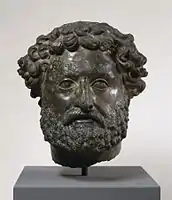 Private portrait with both individualized and unforgiving naturalism and stylized influence of portraits of the emperors Hadrian and Antoninus Pius in his beard and hairstyle.