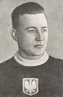 A photo of a young man wearing a sweater with the Polish eagle on the chest
