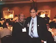 Carlos Castillo-Chavez (right) and physicist Ronald E. Mickens stand at a banquet during the 2012 Ford Fellows Conference