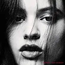 A black and white close-up image of Rosalía, with her name and the album's title in red text on the bottom right.