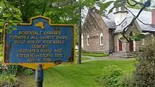 a picture of the marker with the library, which is in a former church, in the background