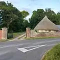 Gate lodge in the style of a rural thatched cottage at Charborough Park, England