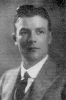 young, clean-shaven white man, with full head of neat dark hair