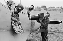 A Type F.8 Mark II (20-inch lens) aerial camera being loaded into a Supermarine Spitfire PR Mk IV at RAF Benson during the Second World War