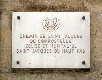 Plaque on the façade of the church stating that it is on the road to Saint Jacques de Compostela