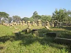 stone pillars in a grass field under blue sky