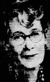 A newspaper photograph of an older white woman, wearing glasses.