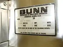 Close-up of the Bunn label on a coffee grinder.