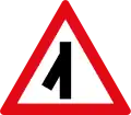 Skewed side road junction ahead to left